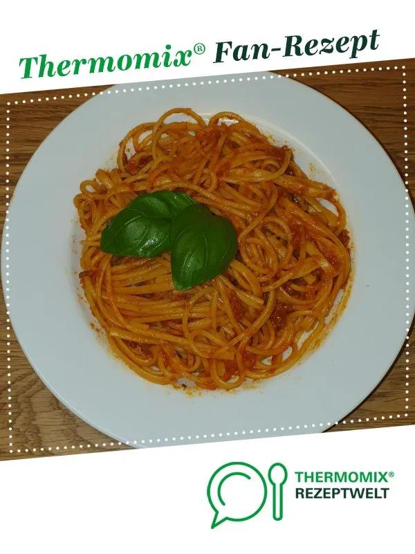 there is a plate of spaghetti with basil on the top and an ad for ...