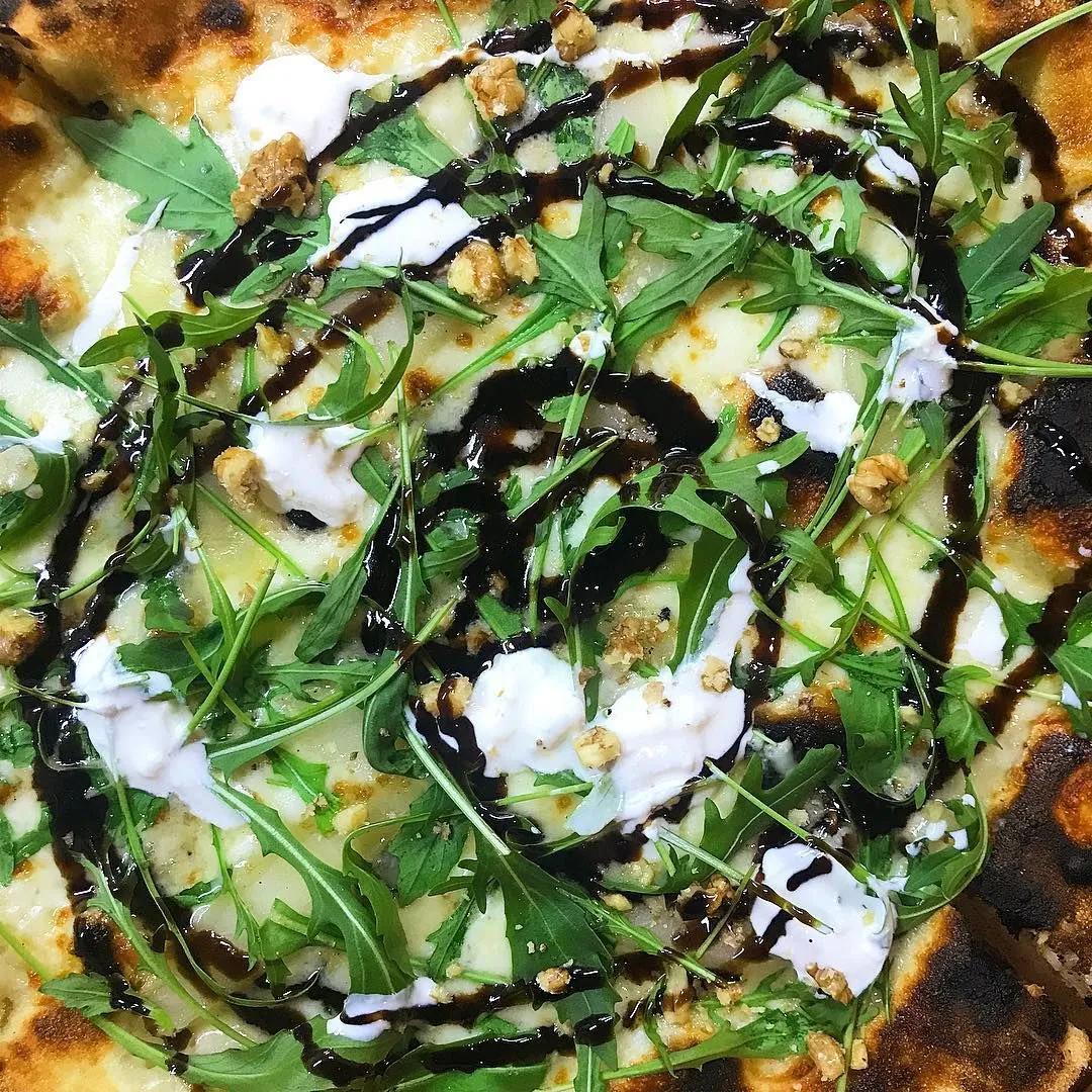 This is our pear and gorgonzola white pizza with rocket, walnuts ...