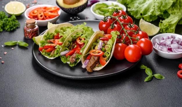Mexikanische tacos mit rindfleisch, tomaten, avocado, zwiebeln und ...