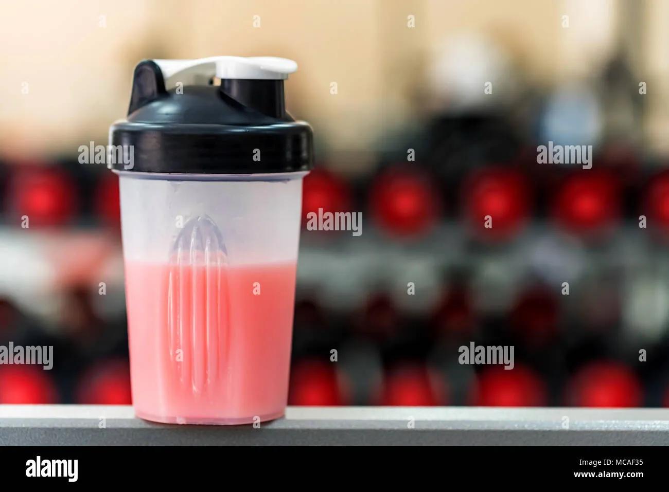 Plastic shaker with fitness cocktail in gym Stock Photo - Alamy