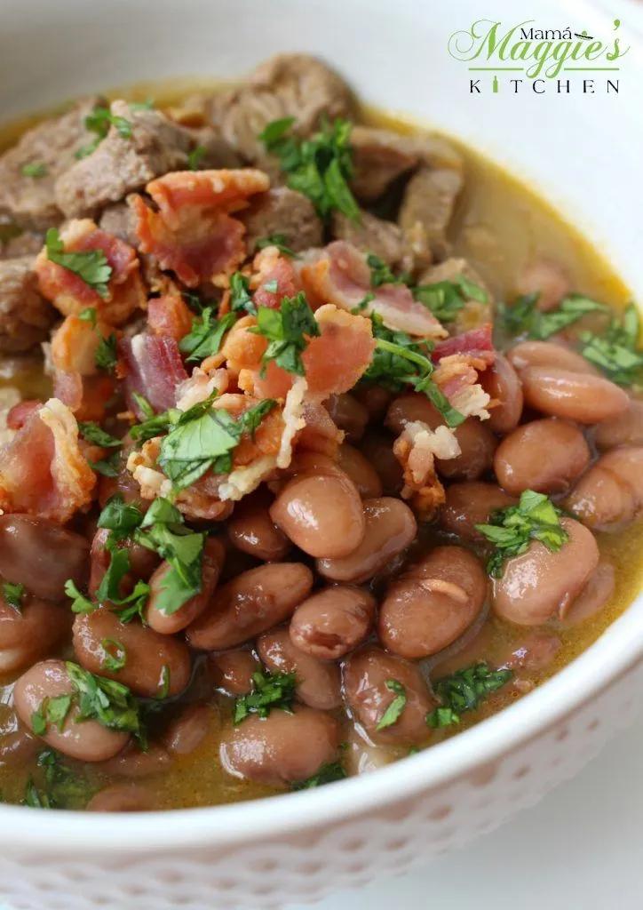 Carne En Su Jugo in a white bowl topped with cilantro beans bacon ...