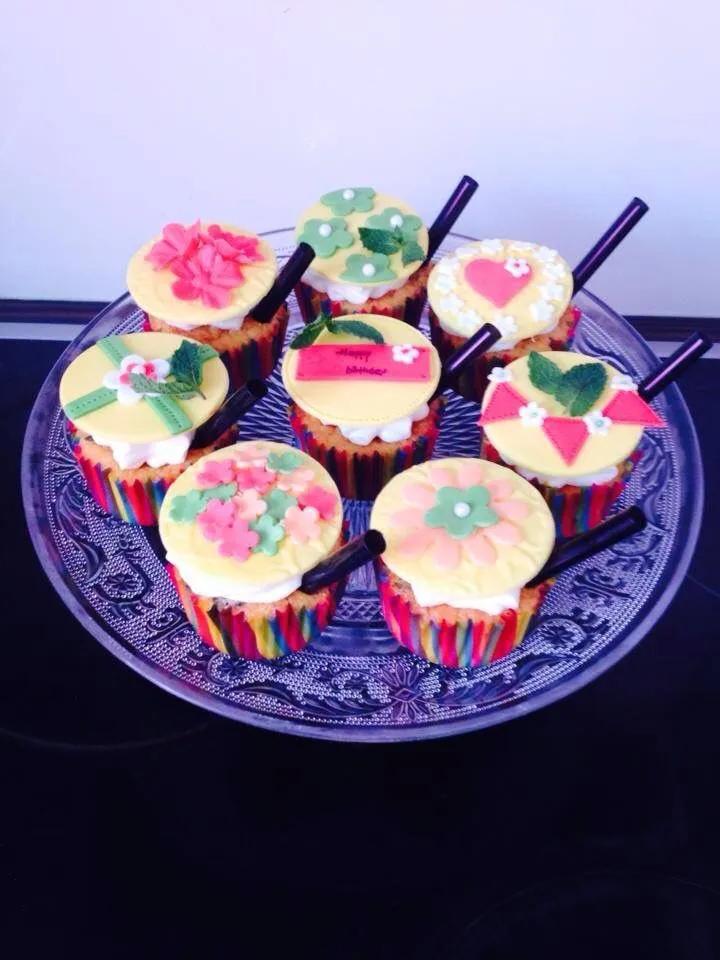 cupcakes decorated with colorful frosting on a blue plate