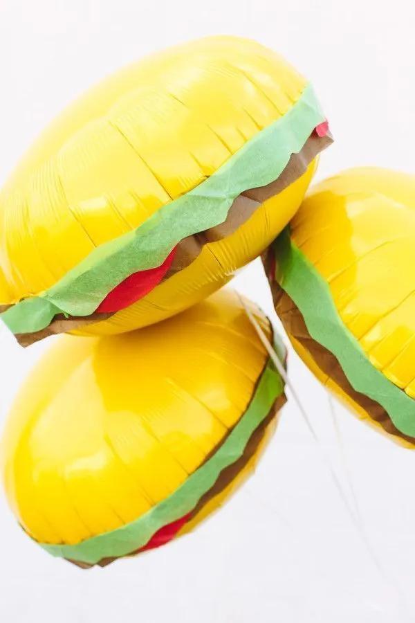 three yellow hamburgers are floating in the air